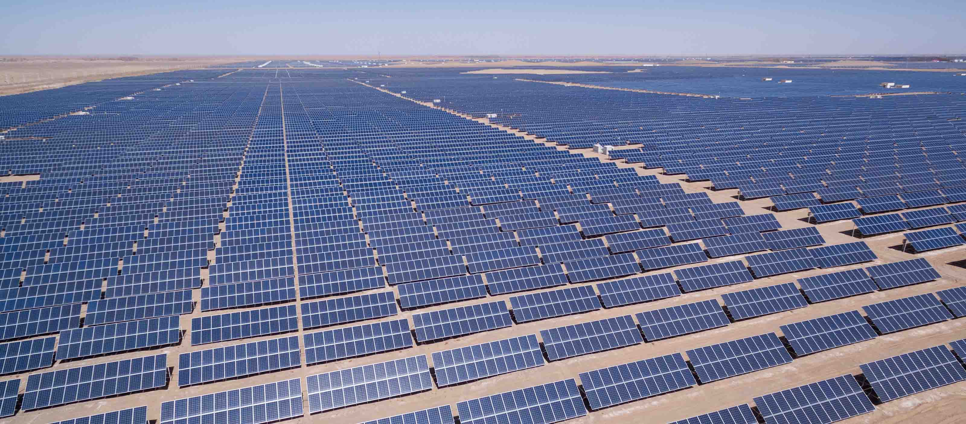 Solar panels in a desert terrain are watched for performance by GE's APM software