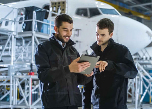 Aviation engineers working together for predictive maintenance using GE Digital solutionsAviation engineers working together for predictive maintenance using GE Digital solutions