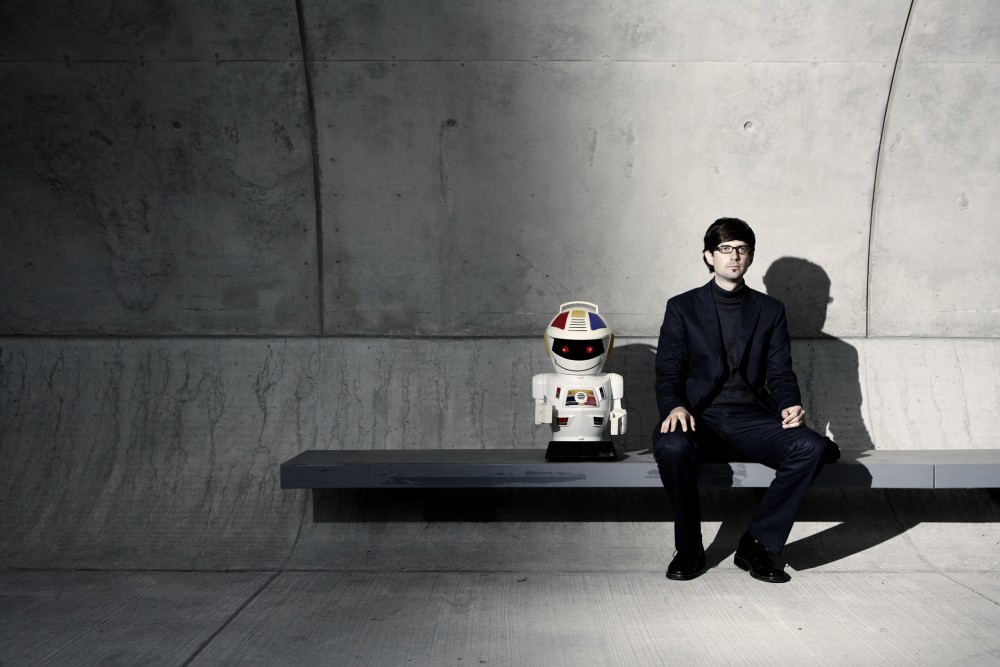 Your robot. Robot sitting board. a girl with good forms sits in a robot.