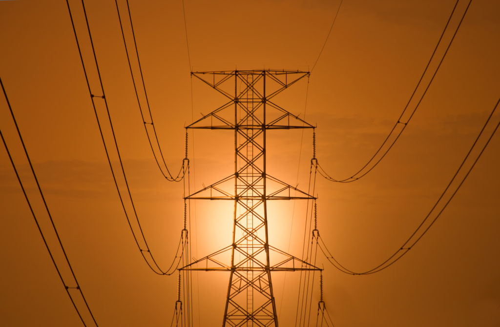 The silhouette of high voltage tower at dawn