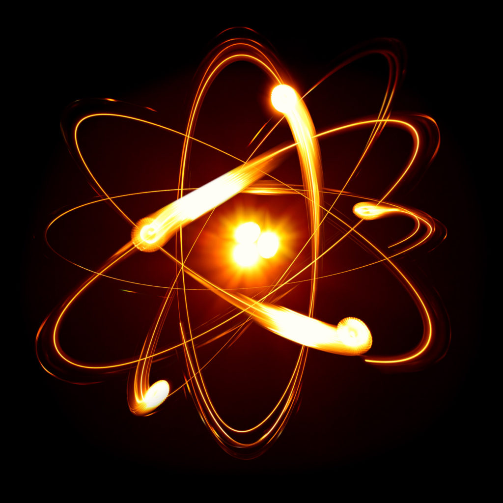 Symbol of atom over black background