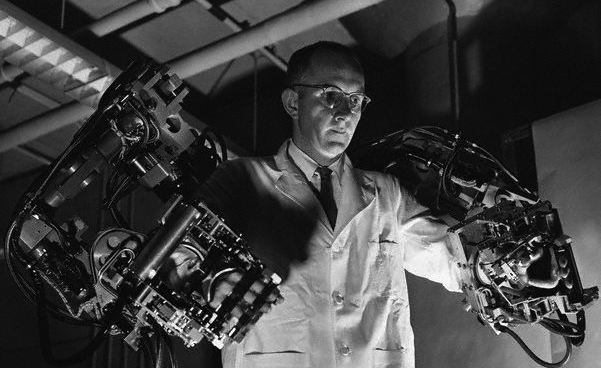 Master control harness which dictates Handyman's movement is manipulated by Ralph Mosher, "father" of machine, at General Electric engineering laboratory here. Slave unit desponds instantly in an exact duplication of motions initiated by the master. Force exerted by the slave until is reflected back to the operator through an intricate electrohydraulic system. The General Engineering laboratory designed and built handyman for the Company's Aircraft Nuclear Propulsion Department (ANPD) of Cincinnatti, Ohio. ANPD will use the manipulator to service radioactivity "hot" components of a nuclear propulsion system for aircraft at its Idaho Test Station at the Atomic Energy Commission's National Reactor Testing Station at Idaho Falls, Ida. --- Image by © Bettmann/CORBIS