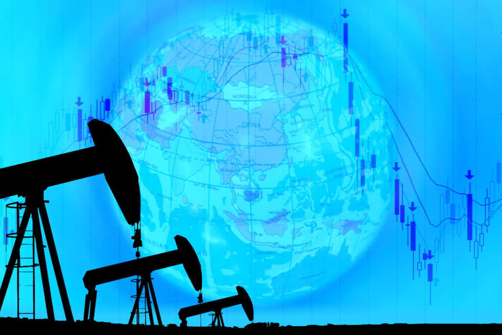 silhouette industrial pump jack and falling oil graph on the blue globe background