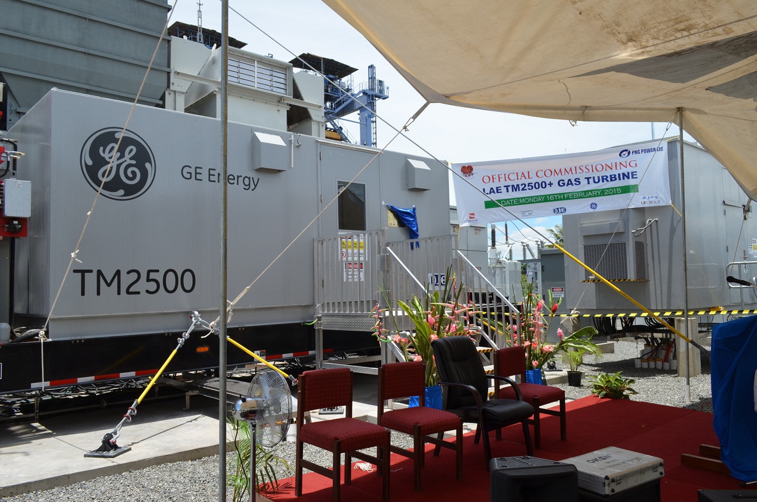  /><br />
<br />
<em>Turbine two installed and ready for commissioning in Lae.</em><br />
<br />
As the Prime Minister prepared to flick the switch on the Lae generator, he said to the crowd of hopeful spectators, “Today our people in Lae city will receive extra 25 megawatts of power, something you didn’t have yesterday or today. That will continue to provide some reliability, and that reliability will go a long way in making sure our people get light, are able to cook, kids are able to study, hospitals are running. All the other services that depend on power will continue to run. So I thank PNG Power and GE and all the engineers who have worked on this to make this possible today.”<br />
<br />
In the time it takes to eat a roast-pork roll and down a beer from Lae’s South Pacific Brewery—about 10 minutes—the Trailer Mounted 2500 had roared into action.<br />
<br />
<em>Main image: Papua New Guineans in traditional dress welcome the arrival of powerful backup to their electricity needs at the commissioning ceremony in Lae.&nbsp;</em>