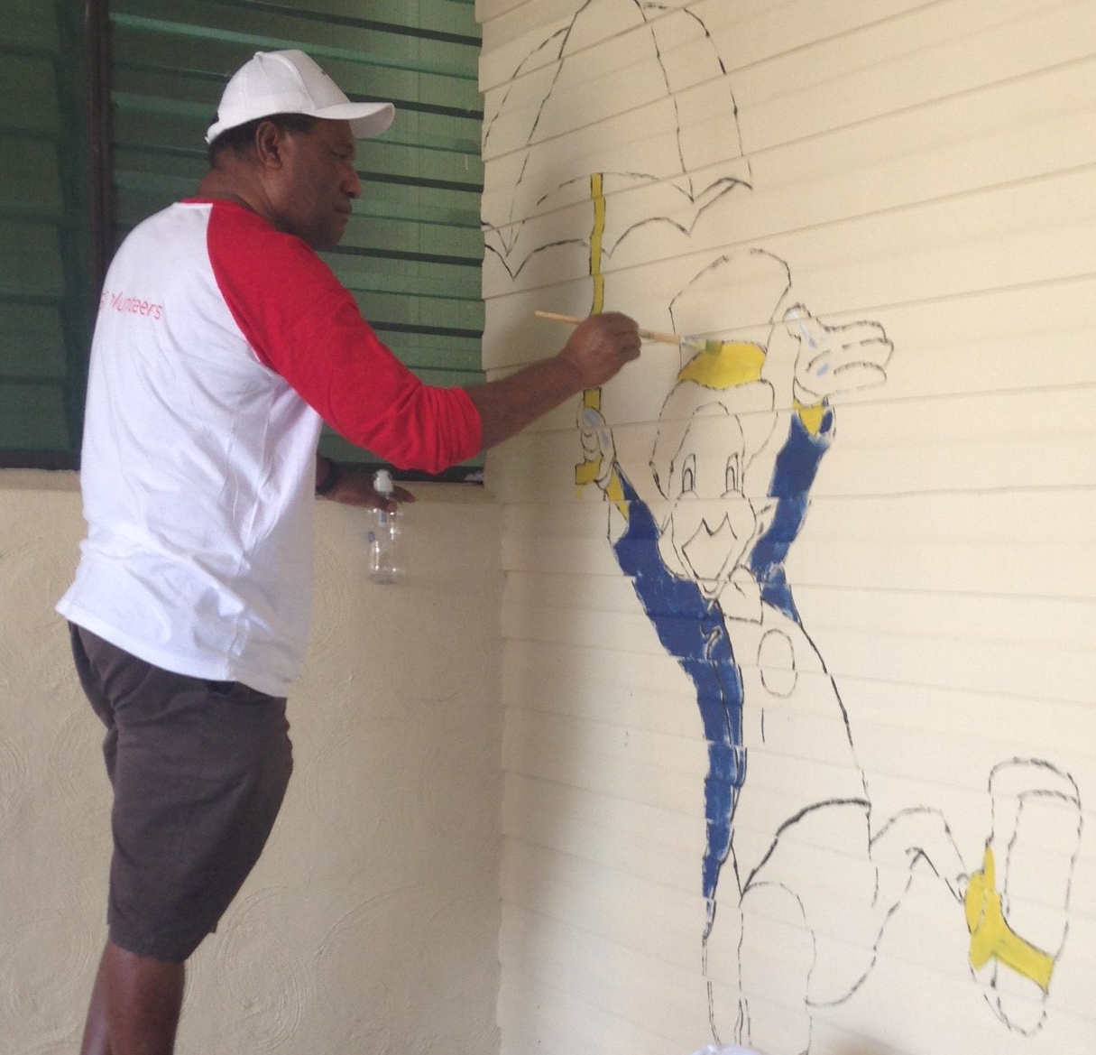  /><br />
<br />
<em>Jiminy Cricket, it’s&nbsp;Peter Loko, Country Head for GE in PNG!&nbsp;</em><br />
<br />
“To get GE Volunteers as part of the foundation for GE’s approach in Papua New Guinea is a really important step,” adds Anderson. “Tui has also reached out to some of our partners in Papua New Guinea—such as Exxon—to understand what they do in corporate social responsibility, and how we can work with them. So we’re not only delivering projects, but also delivering support into the communities where we’re both working.”<br />
<br />
Anderson was inspired by the many family and friends who joined GE&nbsp;employees for the POM Gen project, and looks forward to the next projects there and elsewhere in his region.<br />
<br />
For Tui Alu, hearing reports of the kids’ reactions on finding a wall of Disney characters when they turn up for their checkups is proof that their first project was the right one. “When they come in for their checkups, they sit and face this wall, so we wanted to make sure they had something fun to look at before they go in for their checkups,” explains Alu. “I heard from one woman who took her son in—she said her son wanted to go back there after and sit and stare at all those characters! They’re very bright and colourful. I think I should go back and just watch the kids.”