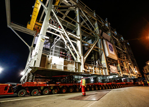  /><br />
<br />
<em>Building the massive, 2,300-ton modules was not the only challenge. When they were finished, the company had to move them through Avenza’s streets to port, and load them onto a ship.</em><br />
<br />
It took the first module 4.5 hours to cover the 500-yard distance between the GE plant and the Marina di Carrara port. The goliath rolled, like a centipede, on 578 computerized wheels attached to four orange self-propelled transporters (<em>see above</em>). At one tight point, the module slid so close past a residential complex that a quarter would have gotten stuck between the structures, GE says.<br />
<br />
GE also had to triple the size of the Avenza plant to more 140,000 square meters (a quarter of the National Mall in Washington, D.C.), to accommodate the structures.<br />
<br />
“We are in the midst of an exciting period for the Australian LNG industry, developing, commissioning and starting-up major projects across the country,” said Mary Hackett, the GE Oil & Gas regional director for Australia, New Zealand and Papua New Guinea. “Our technology is pivotal in all these projects and to helping Australia develop into a world class, and possibly the biggest, LNG exporter.”<br />
<br />
It looks like this goliath is a winner.<br />
<br />
<em>Top image: The first power module arrives on Barrow Island in Western Australia. Above:&nbsp;</em><br />
<br />
<em>This story orginally appeared on&nbsp;<a href=