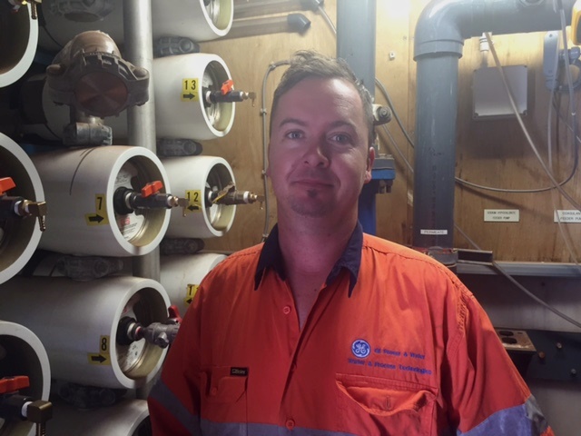 ><br />
<br />
<strong>Kallon Rowe, field service engineer, GE Power & Water</strong><br />
<br />
An hour and 45 minutes’ flight across the red earth, from Perth, GE field service engineers Kallon Rowe and Lewis Manners run an efficient, dedicated tag team—eight days on, six days off—keeping the clean water flowing 24/7 for BHP Billiton in Newman, an iron-ore-mining town of some 9,000 people in the East Pilbara. Newman has nine GE low-flow reverse-osmosis units processing heavily mineralised bore water to deliver up to 12 megalitres of potable water each day, for the town and some mining operations. The containerised units require a constant schedule of monitoring, maintenance and membrane cleaning.<br />
<br />
<strong>Staycation&nbsp;</strong>“I was on for Christmas, Lewis was on for New Year,” says Rowe, and the rotation rolls on throughout the scorching 40+oC summer. “BHP Billiton as a business is relying on us, and so are thousands of people.”<br />
<br />
<strong>Play stations</strong>&nbsp;Rowe and his wife have two young children and are saving for a bigger house, so a getaway might mean waiting for a cool spell: “I’ll get the 4WD out for a north-west holiday—go camping with the family.”<br />
<br />
<strong>2016 Motivation “</strong>I’ve got a couple of personal goals next year. One is to get my Restricted Electrical License. That will enable me to do extra tasks, like change out faulty motors and pumps, and my end goal is to get my Instrumentation certification, which will mean I can do a lot more calibration of instruments. That’s what’s keeping me going at the moment.”<br />
<div style=