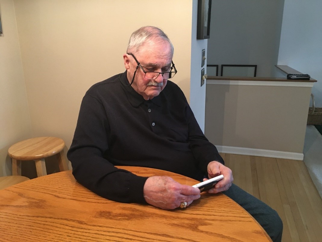 A man using the KardiaMobile app to check his heart-rhythm history and watch for signs of arrhythmia.  Credit: GE Healthcare