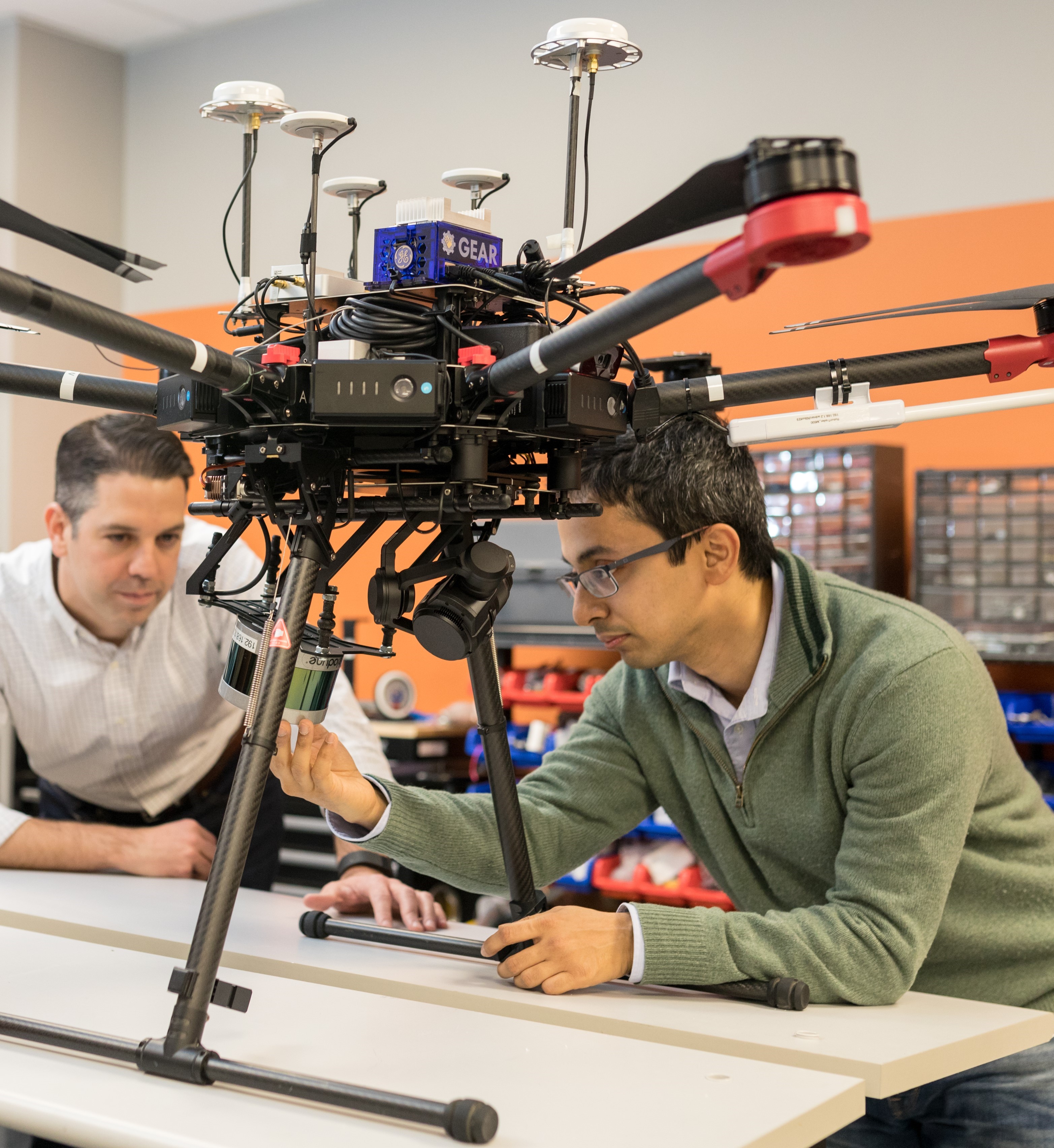 John Lizzi and Shiraj Sen working on a drone in the robotics lab