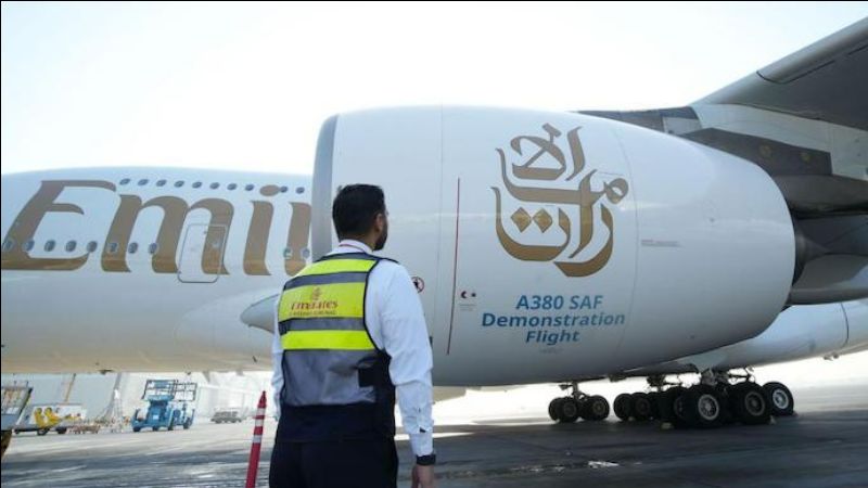 A person standing next to a large white airplane
Description automatically generated