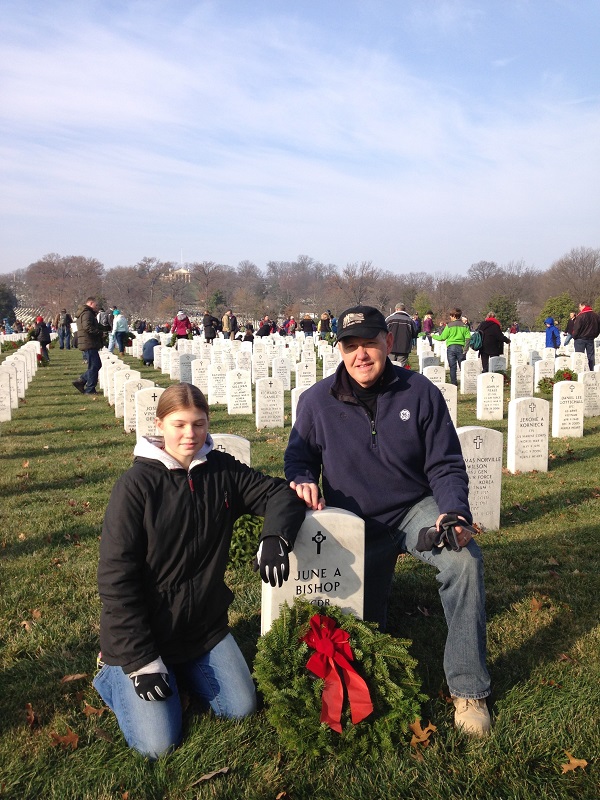 Chip Cotton with daughter Kayleigh at Arlington National cemetery at a Wreaths Across America event.  (LCDR June Bishop was in the second class of graduating females from USNA – she worked for me on the CNO staff)