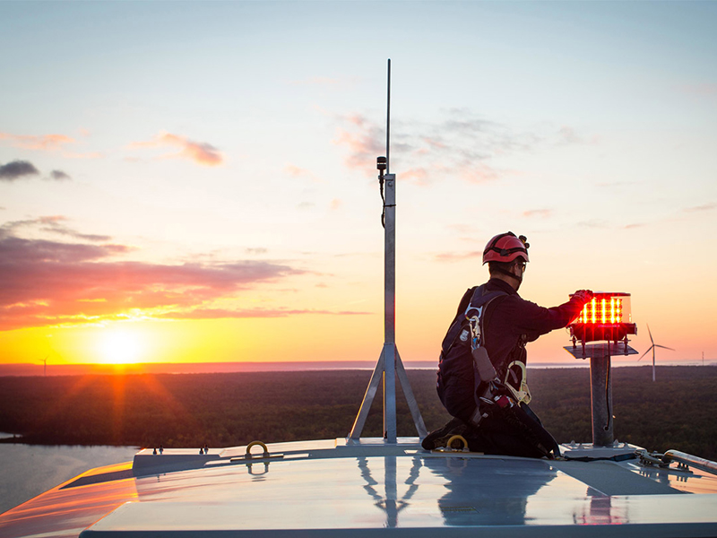 Person working on top o Wind Turbine